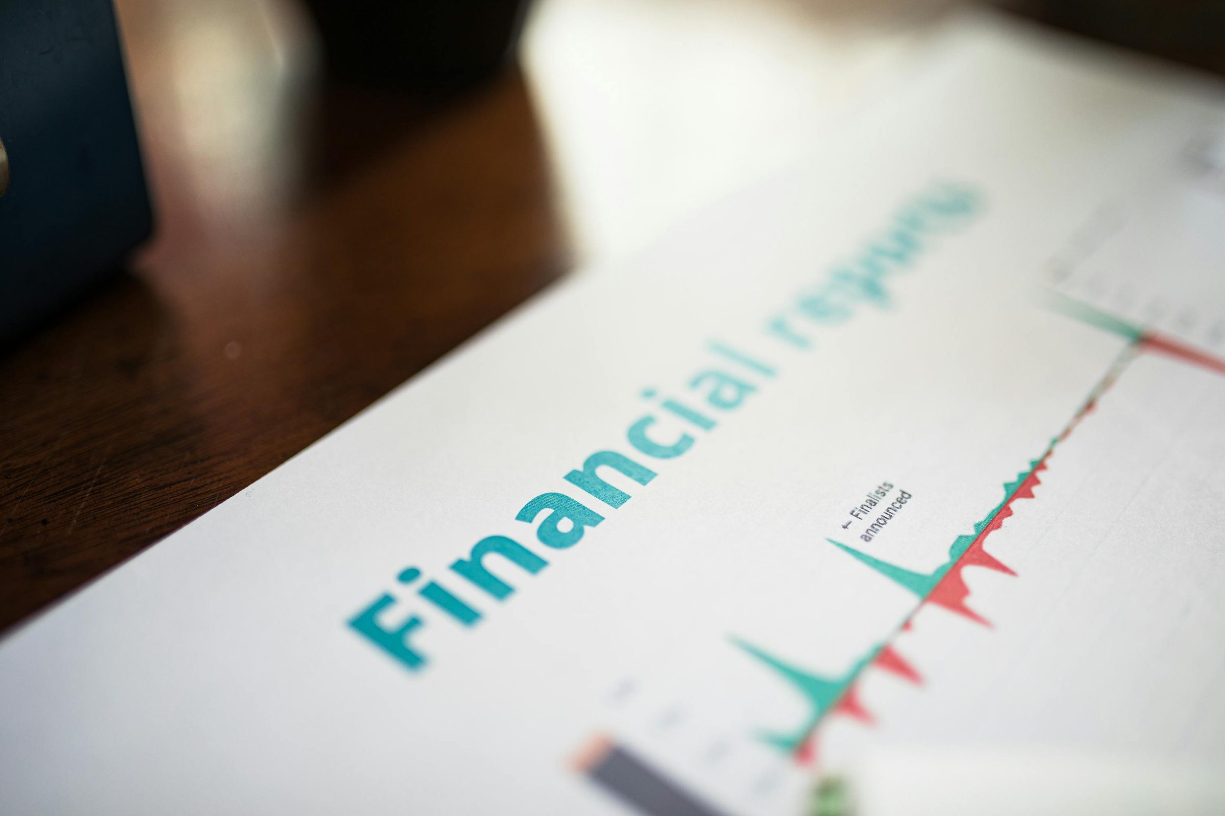 A printed financial report with trend charts — the physical form of a commissioned sovereign analysis